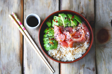 Poke bowl with rice, salmon and avocado. Sushi bowl.