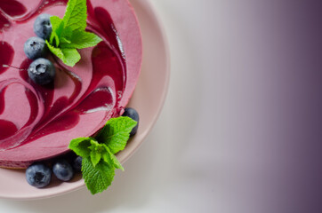 Baked vanilla and berries flavour cheesecake swirled with blueberry sauce on a digestive biscuit crumb