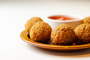 Southern fried chicken bites with tomato dip, chopped and shaped chicken breast with coated in southern fried seasoned breadcrumbs