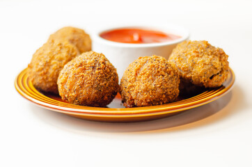 Southern fried chicken bites with tomato dip, chopped and shaped chicken breast with coated in southern fried seasoned breadcrumbs