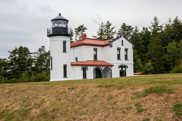 Fototapeta na wymiar Whidbey Island, Washington, USA - May 23 2021: Admiralty Head Lighthouse at Fort Casey State Park in Washington during summer.