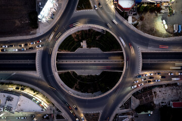 Aerial drone top view of a modern motorway junction roundabout with cars moving. Transportation...