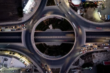 Foto op Canvas Aerial drone top view of a modern motorway junction roundabout with cars moving. Transportation infrastructure, © Michalis Palis