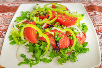 A simple summer salad with tomatoes and greens is a healthy snack