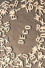 Deco Word In Wooden Cube Alphabet Letters Top View On A rustic paper Background.