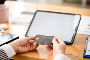 young woman holding credit card and using a laptop computer business woman working from home, online shopping, ecommerce, internet banking, spending money, finance, work from home concept..