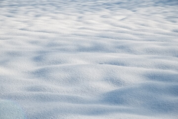 Snow mounds and mogels in fresh powder snow with light shadows