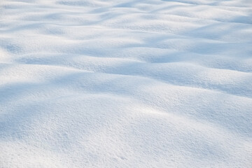 Snow mounds and mogels in fresh powder snow with light shadows