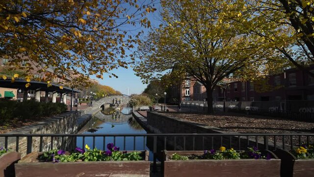 Carroll Creek Park in historic district of Frederick with shops and building on sides of the canal.
