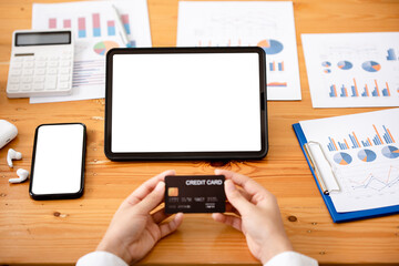 young woman holding credit card and using a laptop computer business woman working from home, online shopping, ecommerce, internet banking, spending money, finance, work from home concept..