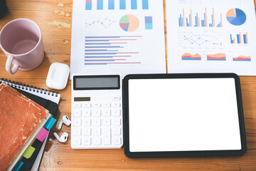 modern office with blank screen tablet and office equipment on the table