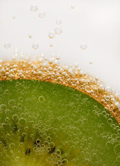 Kiwi close-up on a light background with air bubbles