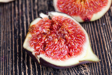 ripe purple figs on a wooden table