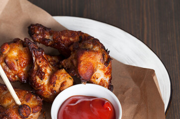 baked chicken wings together with ketchup