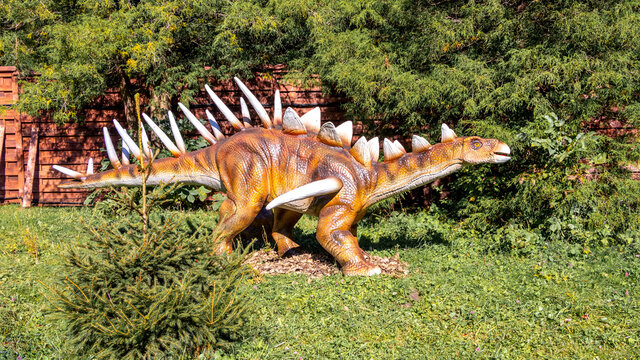 Ukraine, Khmelnitsky, October 2021.  Dinosaur model in the park. Giant kentrosaurus at an exhibition in the park on a summer sunny day