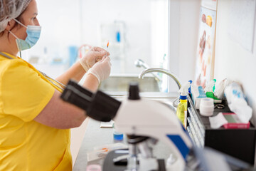 Woman veterinarian examines blood test in laboratory