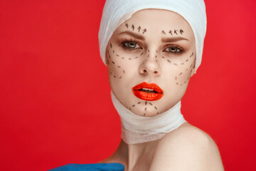 portrait of a woman posing in blue gloves red lips surgery facial rejuvenation studio lifestyle
