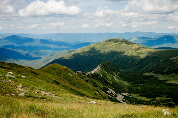 Fototapeta na wymiar Incredibly beautiful panoramic views of the Carpathian Mountains. Peaks in the Carpathians on a background of blue sky