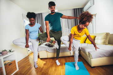 Healthy morning stretching - family doing gymnastic exercise at home