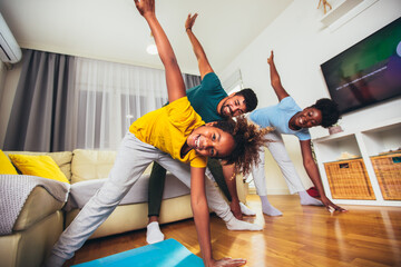 Healthy morning stretching - family doing gymnastic exercise at home - Powered by Adobe