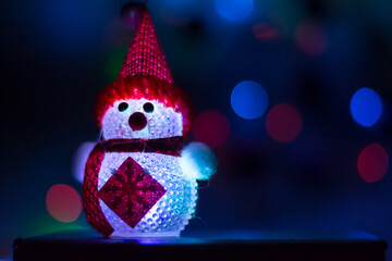 close-up toy snowman with bokeh effect