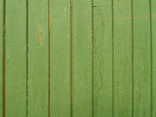 Background of a wooden fence painted green. Green boards. - 468840323