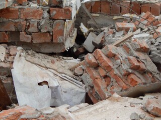 Fragments of a brick wall. Ruins of a demolished house. - 468840333