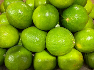 Limes background. Closeup of fresh green limes in the grocery store