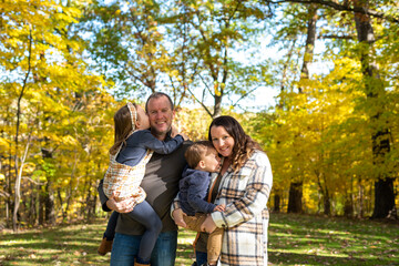 Happy young couple with two little kids