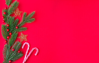 New year or Christmas border with pine branches, golden stars and candy cane on red
