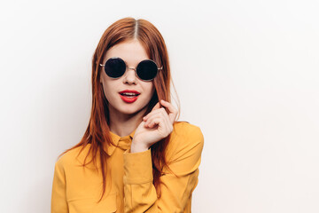 fashionable woman in yellow shirt sunglasses posing