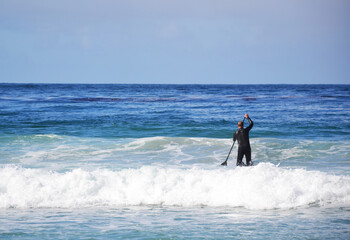 Man surfing in the ocean near California beach