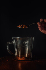 pouring coffee grains in a cup
