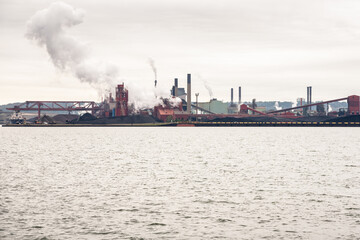 View of a waterfront steel mill on a cloudy autumn day