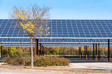 Solar panels over an empty outdoor car park on a sunny autumn day