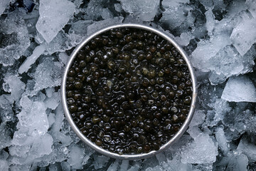 Caviar in a metal box on ice seen from above