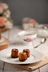 Bordeaux caneles on a plate with tea