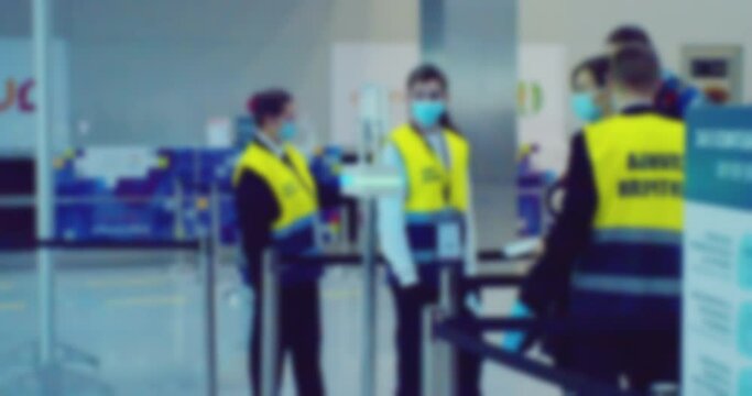 modern city life. security service checks people. blurry defocused video. silhouettes of unrecognizable people in a large bright hall.
