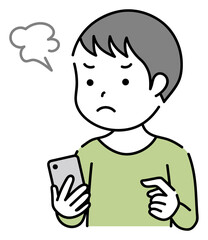 スマホを操作するイライラしている子供　男の子