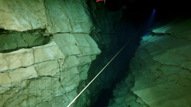 Budapest - 17 August 2017: Technical diver in red flippers in the underwater cave of Budapest