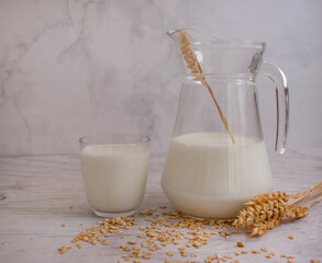  oat milk in a glass on a wooden background