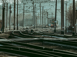 Fototapeta na wymiar Palisade of pillars and flourishes of wires at a railway station