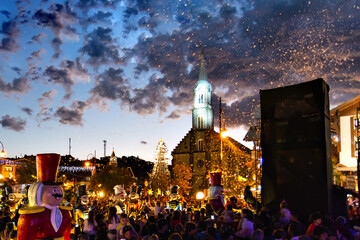 a church decorated for Christmas in the late afternoon with snow and Christmas lights