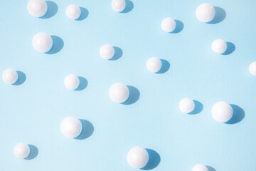 Snowballs on pastel blue background. New Year and Christmas idea. Minimal abstract winter holidays concept. Copy space.