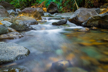 Fototapeta na wymiar slow shutter speed of soft water and rocks river in jungle 