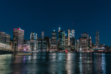 Fototapeta na wymiar city skyline Manhattan New York beautiful reflections lights skyscrapers buildings bay 