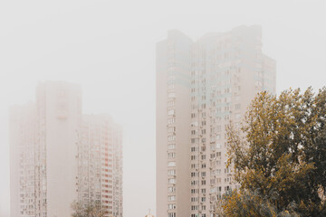 Tall residential buildings in smoke. Pollution. Architecture. Facade. Area. District. Population....