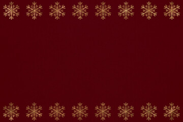 Golden rows of snowflakes on a  red canvas, golden frame, seasonal background, card, postcard, greetings, holiday