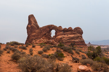 One of the most impressive arches in the Arches National Park, Turret Arch, in overcast day. View from the trail © Victoria Ditkovsky