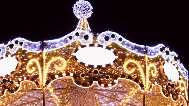Holiday carousel decorated with garlands. 